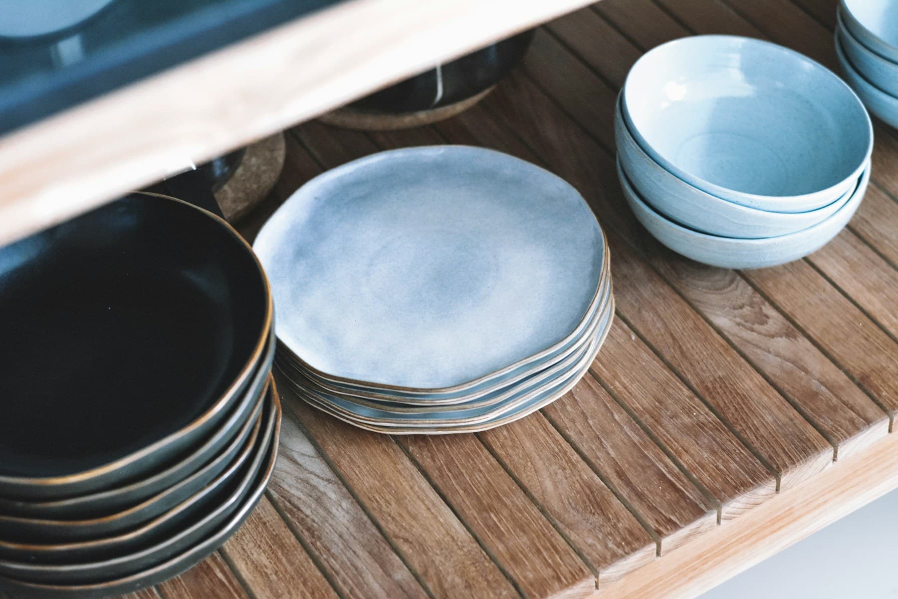 Handmade ceramic pieces arranged on studio shelving